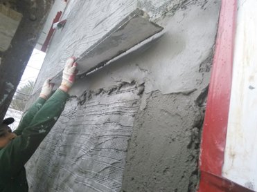 A screed is set between the window and edge of the wall.