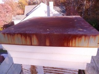Rusted chimney cap on fake stucco house in Fairfax,
                VA