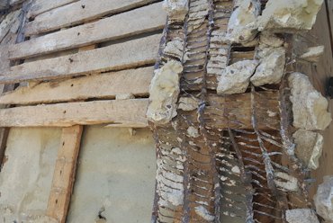 Old wood lath was held away from the wall with vertical furring strips