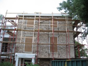 building with stucco stripped off