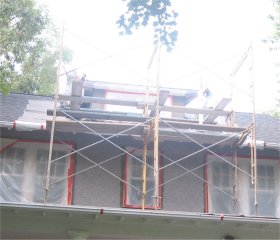 Scaffold on roof to stucco dormer