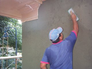 A bonding coat is applied to the old stucco