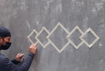 Design is marked off on the stucco brown coat.