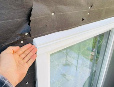 Top flange of flashing is overlapped with tar paper.