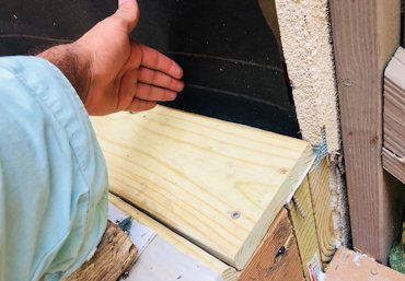 Flange on flashing is overlapped with tarpaper