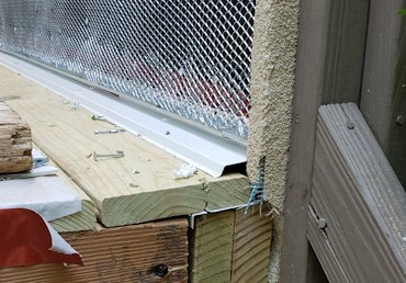 gap is left between the plaster stop and the flashing for drainage