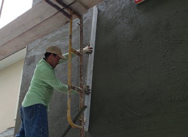 cement mortar is put on and rodded off with a 6 foot rod.