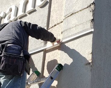 Area with truck scrapes was covered over with lath and stucco