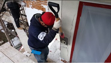 EIFS is stripped off with garden spades in Bethesda, Maryland