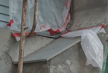 Bolts are hidden with flashing and mortar.
