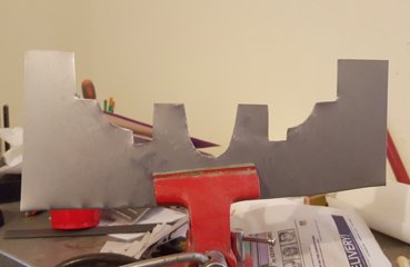 I traced the image on metal and cut and filed the
                knife in a vise