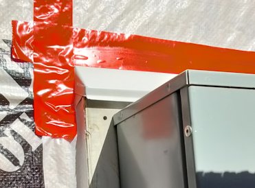 Electrical panel is bolted to a board.