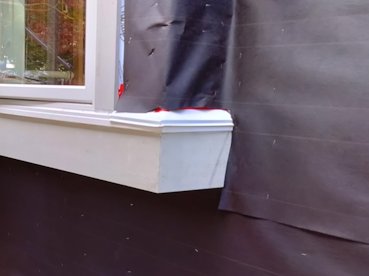 very horizontal trim board has flashing put on.