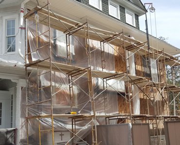 Stucco off, the wall is covered with plastic in case of rain.