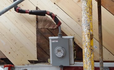 Rotted wood sheathing boards are replaced.