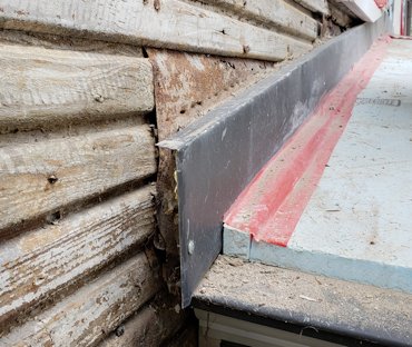 Metal lath is nailed on and the bands are filled in.
