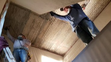 Metal lath is screwed over the old wood lath