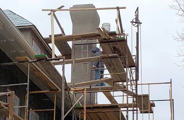 Color finish is put on chimneys and dormers.