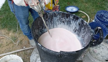 Color is mixed in a garbage can.