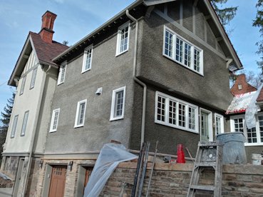 Pebble dash stucco is matched exactly on this 1920 house.