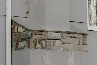 Flagstone chimney shoulders are flush with edge of the stone