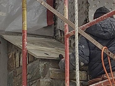 New flagstone shoulders project past the edges allowing water to drip off away from the chimney.