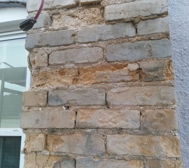 Stucco stop flashing is nailed on the brick