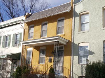 Bright Sante FE style colors liven up this stucco townhouse in Washington, DC