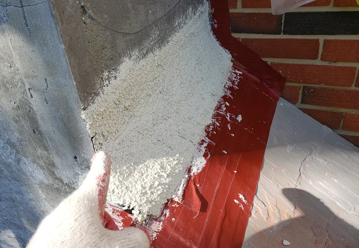 flagstone chimney shoulder is covered with flashing.