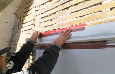 Flashing is put on over the windows and taped.