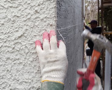 The wall is staightened by setting a string line.