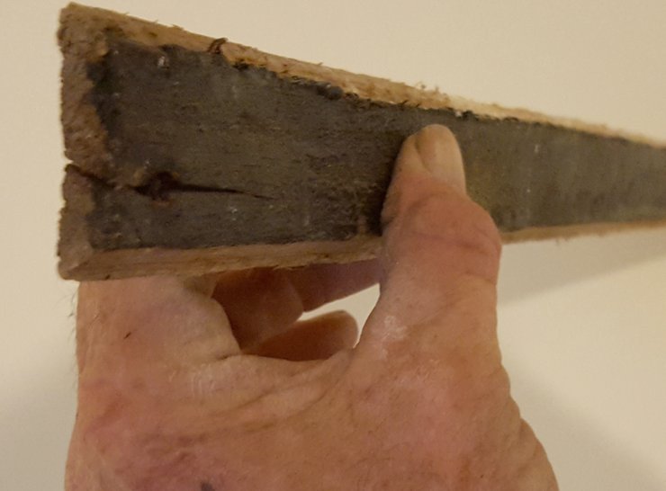 A smart person back in 1921 painted the back of the wood lath with tar.