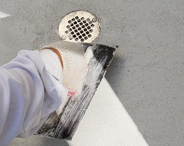 Finish coat covers the pipe, allowing water to run into the grate in West Virginia.