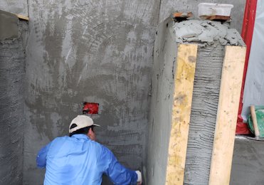 Wood strips are set and the walls are filled in and rodded off