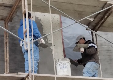 One coat stucco is chipped and a bonding coat applied