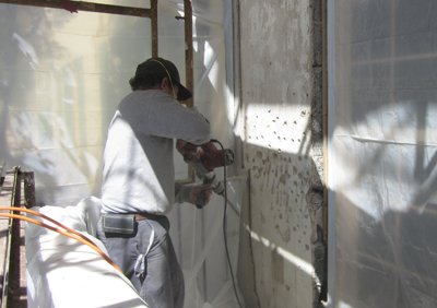 The old
              wall is chipped up with an electric chipping hammer