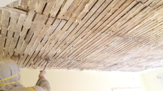 old lime and sand plaster is stripped off in Baltimore, Maryland.
