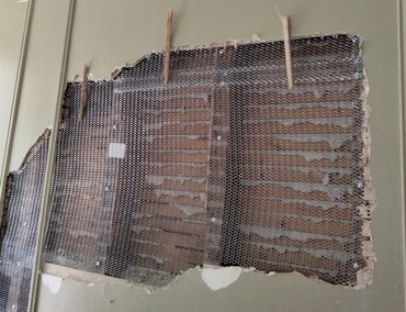 Bump in wall is straighted by removing the wood lath to add space.