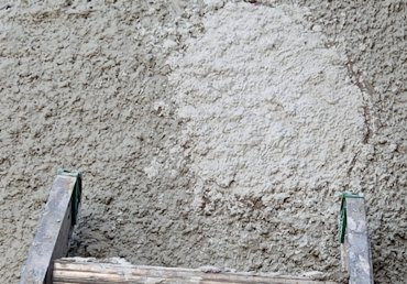 Above the window and other loose areas are cut out and filled with lath and stucco