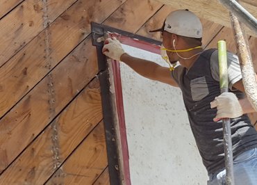 The framing wrapped with tar paper before the original window was installed