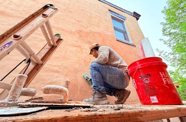 Stucco was used on old brick walls to stop water intrusion