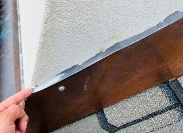 Flashing is put on over the stucco, and not under the stucco