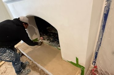 The hearth is formed and filled with hardwall (gypsum plaster) and sand