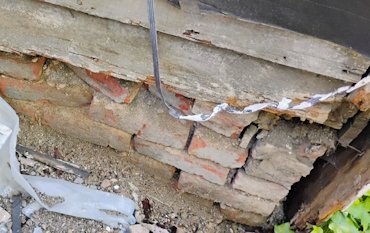 old lime and sand mortar had washed completely out of the brick foundation.