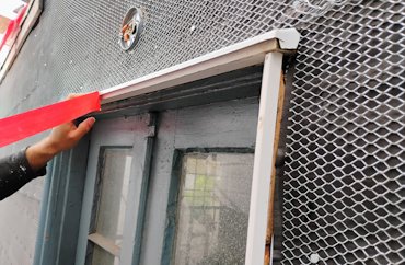 Metal flashing is put on over the windows and doors.
