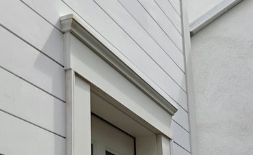 The freshly renovated house next door doesn't have any flashing over the door trim