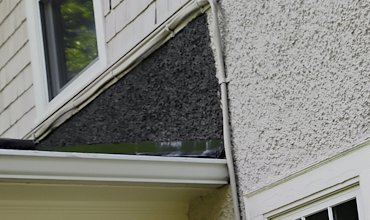 New flashing is put on the roof line and pebble dash stucco is patched