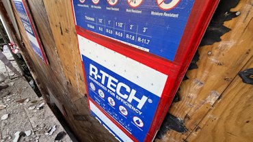 Windows are covered with styrofoam before tearing off the stucco.
