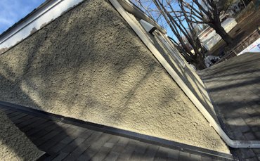 Stucco is replaced on the dormer with new flashing.