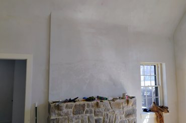 finished fireplace curves into the ceiling.